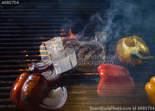 Image of steak with vegetables on a barbecue