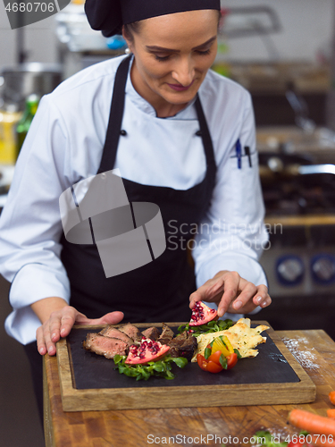 Image of female Chef preparing beef steak