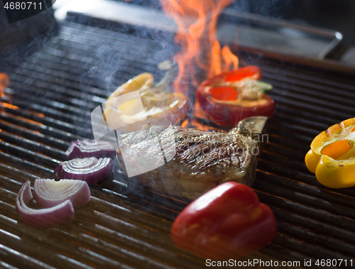 Image of steak with vegetables on a barbecue