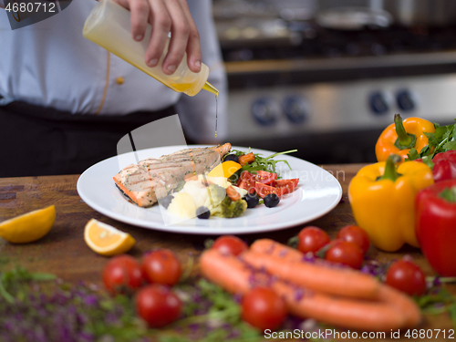 Image of Chef finishing steak meat plate