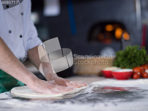 Image of chef preparing dough for pizza