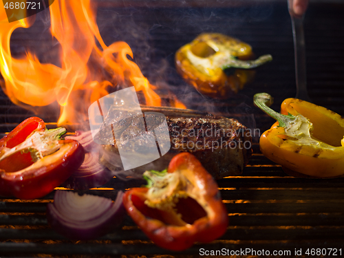 Image of steak with vegetables on a barbecue