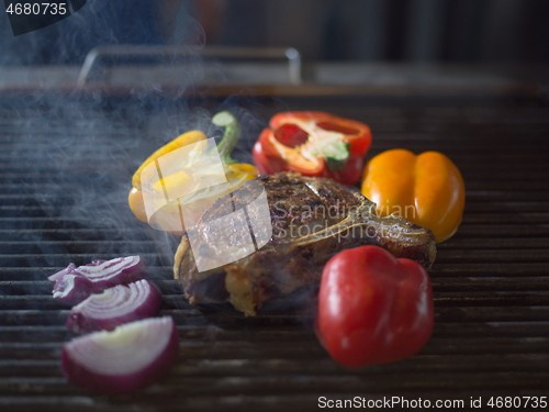 Image of steak with vegetables on a barbecue