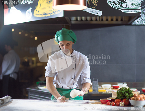 Image of chef hands preparing dough for pizza