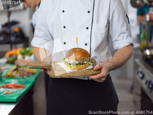 Image of chef finishing burger