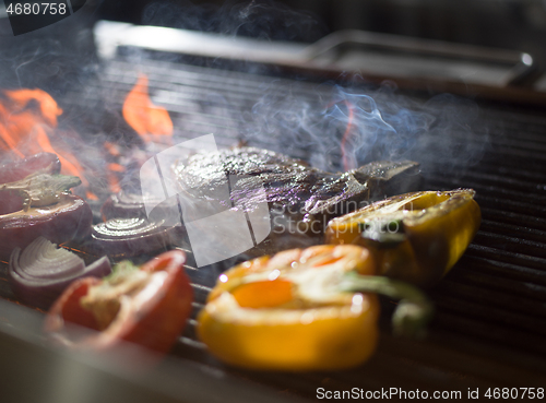 Image of steak with vegetables on a barbecue