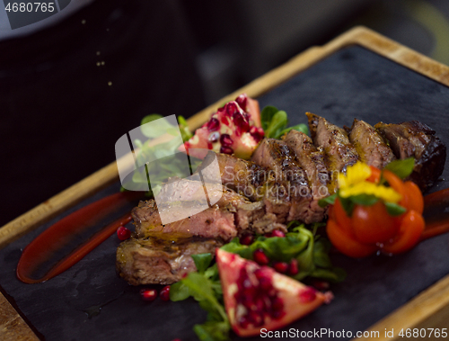 Image of Chef finishing steak meat plate