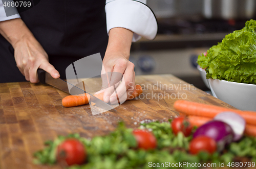 Image of chef hands cutting carrots