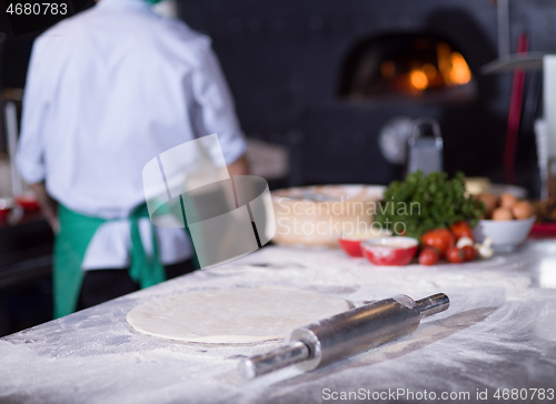 Image of chef preparing dough for pizza