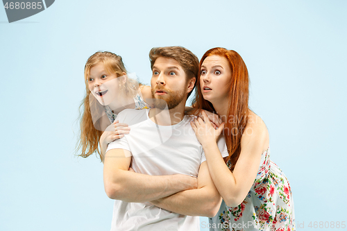 Image of Happy parent with daughter at studio isolated on blue background