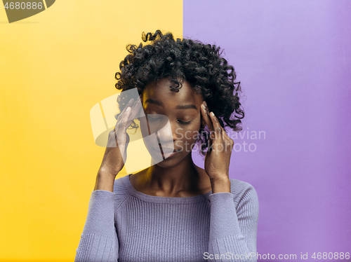 Image of Woman having headache. Isolated over gray background.