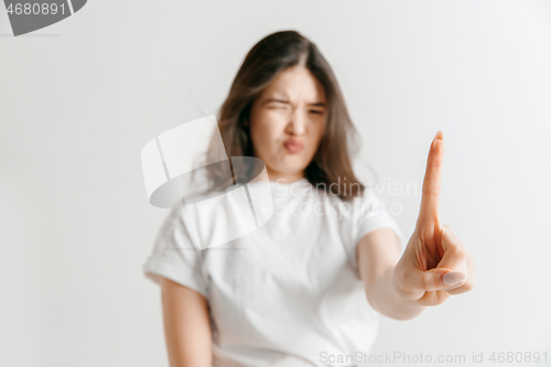 Image of Woman\'s hand with finger on gray background