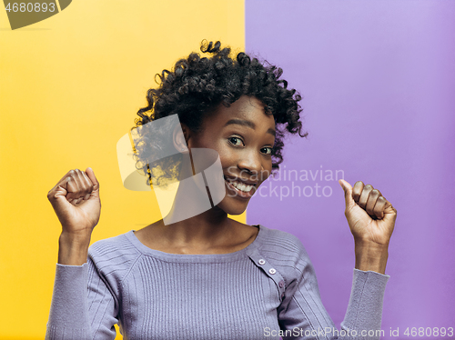 Image of Winning success woman happy ecstatic celebrating being a winner. Dynamic energetic image of female afro model