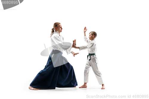 Image of Man and teen boy fighting at aikido training in martial arts school