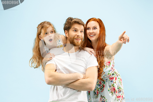 Image of Happy parent with daughter at studio isolated on blue background