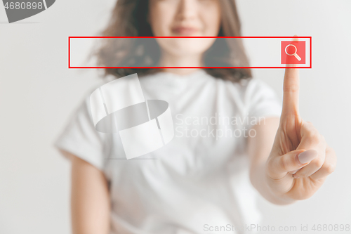 Image of Woman\'s hand with finger on gray background