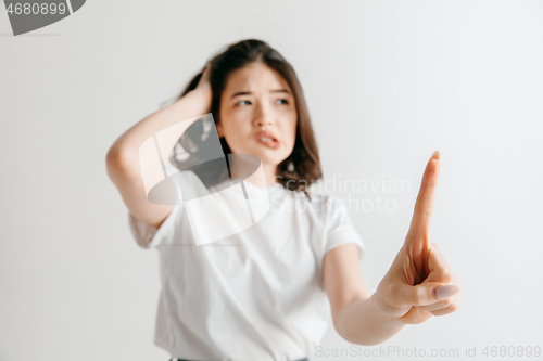 Image of Woman\'s hand with finger on gray background