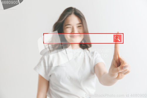 Image of Woman\'s hand with finger on gray background