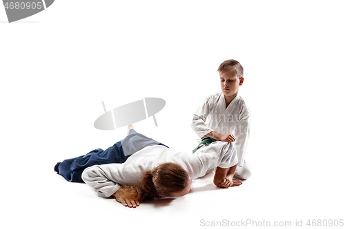 Image of Man and teen boy fighting at aikido training in martial arts school