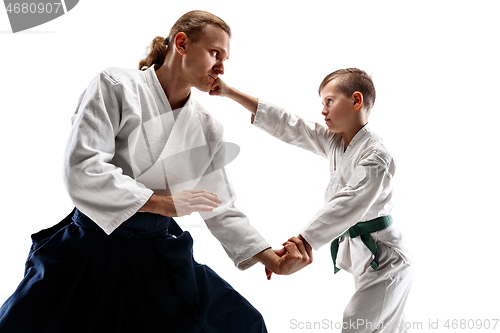 Image of Man and teen boy fighting at aikido training in martial arts school