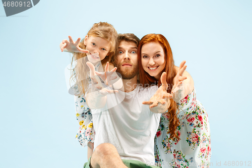 Image of Happy parent with daughter at studio isolated on blue background