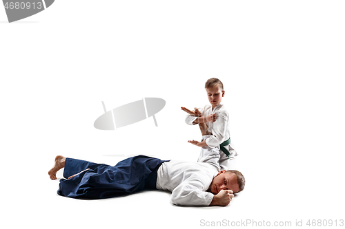 Image of Man and teen boy fighting at aikido training in martial arts school