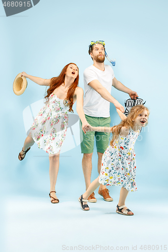 Image of Happy parent with daughter at studio isolated on blue background