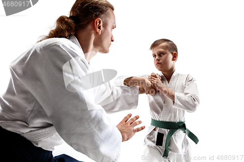 Image of Man and teen boy fighting at aikido training in martial arts school