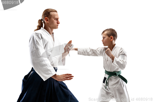 Image of Man and teen boy fighting at aikido training in martial arts school