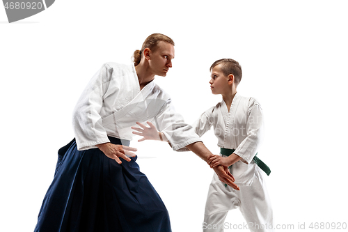 Image of Man and teen boy fighting at aikido training in martial arts school