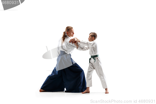 Image of Man and teen boy fighting at aikido training in martial arts school