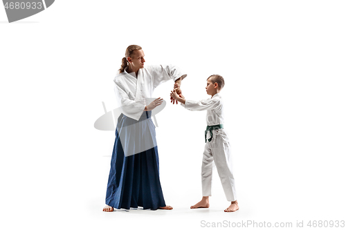 Image of Man and teen boy fighting at aikido training in martial arts school