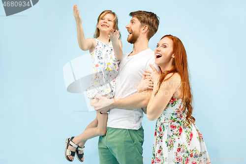 Image of Happy parent with daughter at studio isolated on blue background