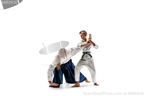 Image of Man and teen boy fighting at aikido training in martial arts school