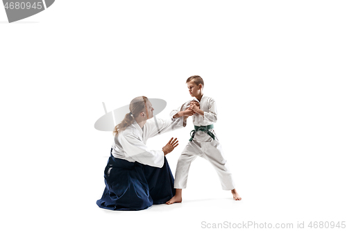 Image of Man and teen boy fighting at aikido training in martial arts school