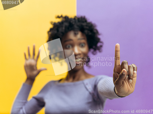 Image of Woman\'s hand with finger on blue background