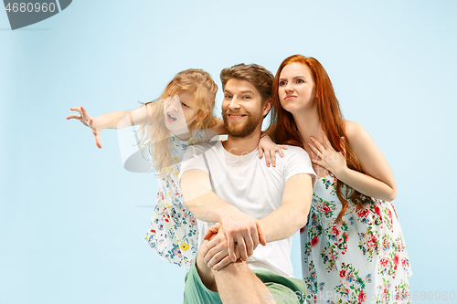 Image of Happy parent with daughter at studio isolated on blue background