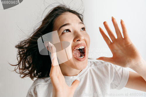 Image of Isolated on pink young casual woman shouting at studio