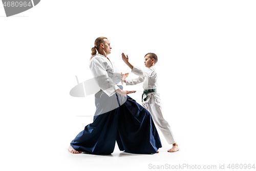 Image of Man and teen boy fighting at aikido training in martial arts school