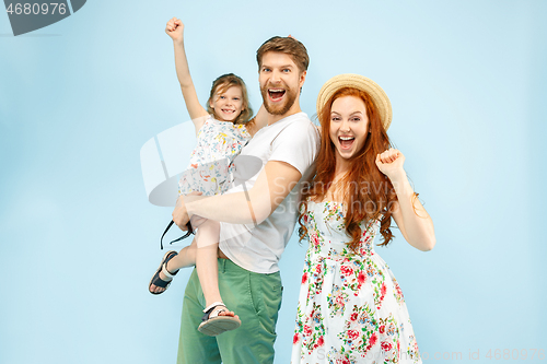 Image of Happy parent with daughter at studio isolated on blue background