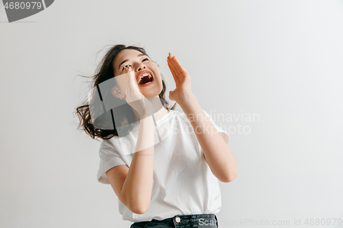 Image of Isolated on pink young casual woman shouting at studio