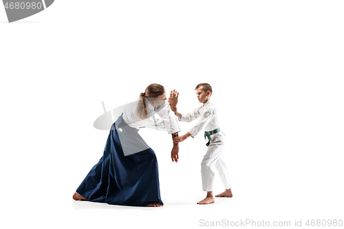 Image of Man and teen boy fighting at aikido training in martial arts school