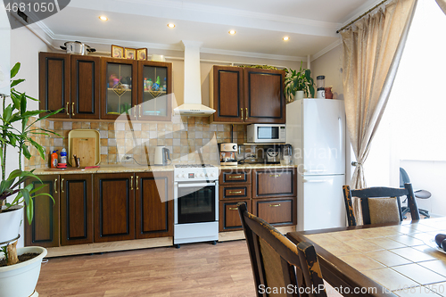 Image of Classic wood grain kitchen set and dining table in the interior of the kitchen