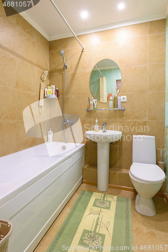 Image of Interior of an ordinary standard classic bathroom joint with a toilet