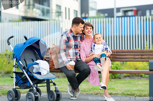 Image of family with baby in stroller and coffee in city