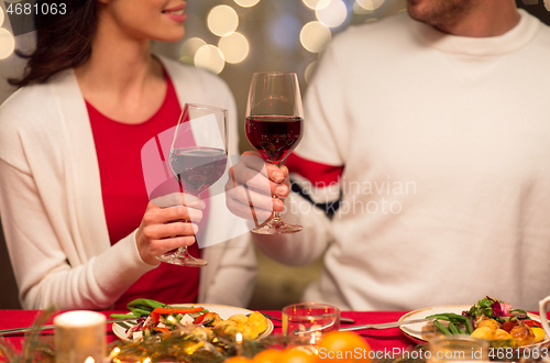 Image of close up of couple drinking red wine on christmas