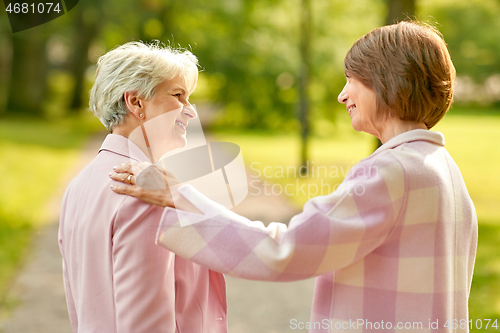 Image of senior women or friends talking at summer park