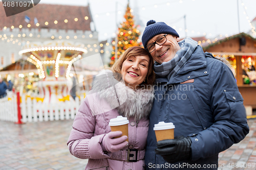 Image of senior couple with coffee at christmas market