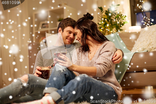 Image of happy couple drinking coffee and eating at home