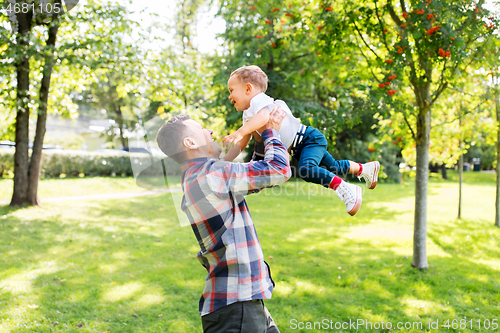 Image of happy father with son playing in summer park